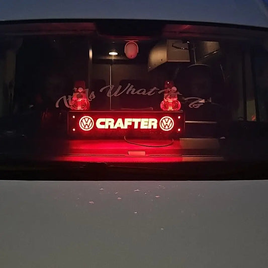 Rear interior of a Volkswagen Crafter van showcasing the MERCEDES SPRINTER LED Dash Table (2018-24) with red-glowing CRAFTER LED sign near back window.