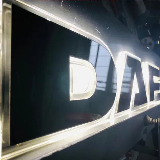 DAF Grille Badge Led Back-Lit sign with cut-out letters on an acrylic panel, LED modules shining through, enhancing vehicle style and visibility.