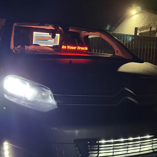 Citroën vehicle at night with illuminated headlights and In Your Truck sign, showcasing the Toyota Proace/Peugeot Expert/Citroen Dispatch Dash Table on its dashboard.