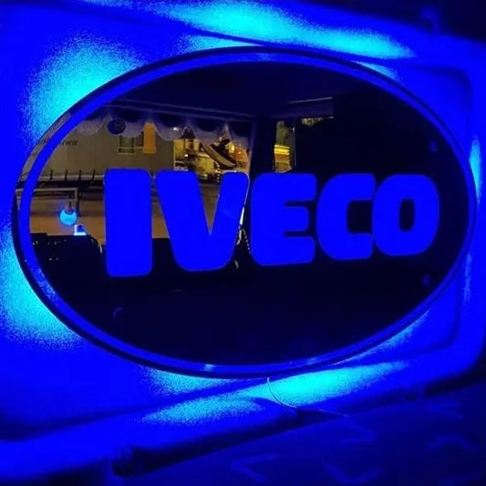IVECO INTERIOR MIRROR / LIGHT BOARD 60x40cm with illuminated blue logo, mounted on a truck, featuring LED RGB lighting and remote control functionality.