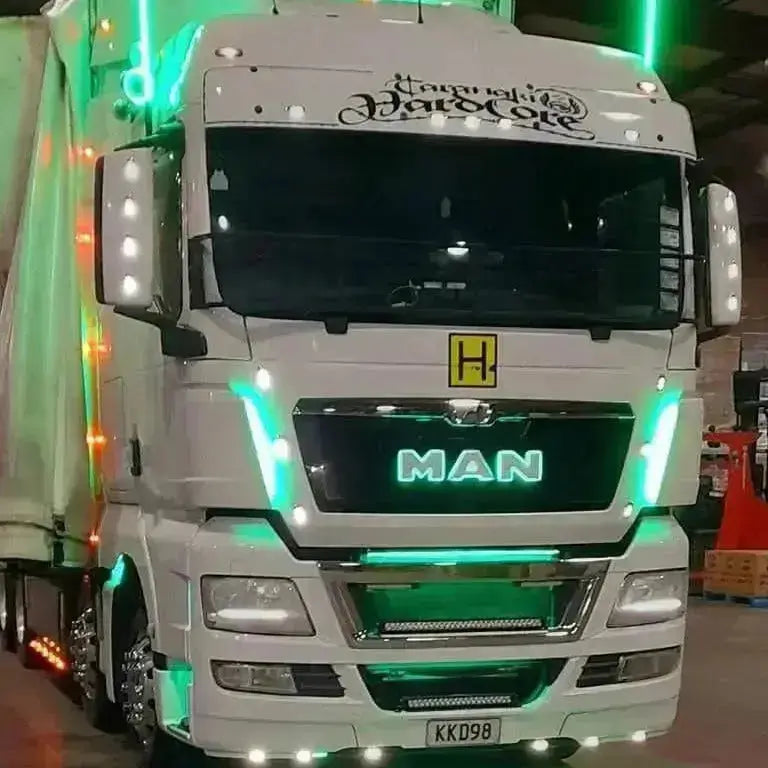 MAN semi truck with green LED accents, featuring Mercedes Truck LED Front Grille Badge Backlight Base Actros MP4/5 340mm, highlighting the illuminated grille and bumper.