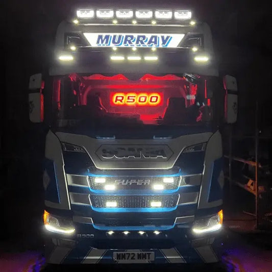 Scania R/S Series Truck Light Board on a cab-over semi-truck, featuring illuminated “R500” sign, “MURRAY” light bar, and decorative LED lights.