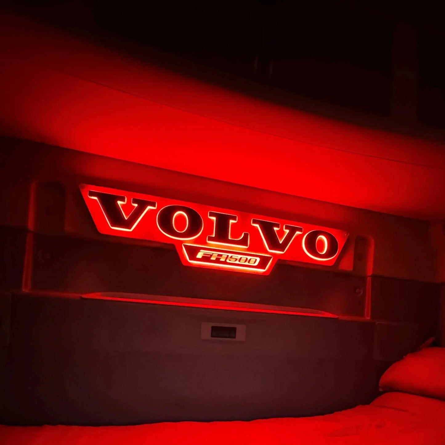 Volvo Truck LED Light Board in a glowing red lorry cabin, showcasing the illuminated “VOLVO” badge and “FH500” emblem on the back wall.