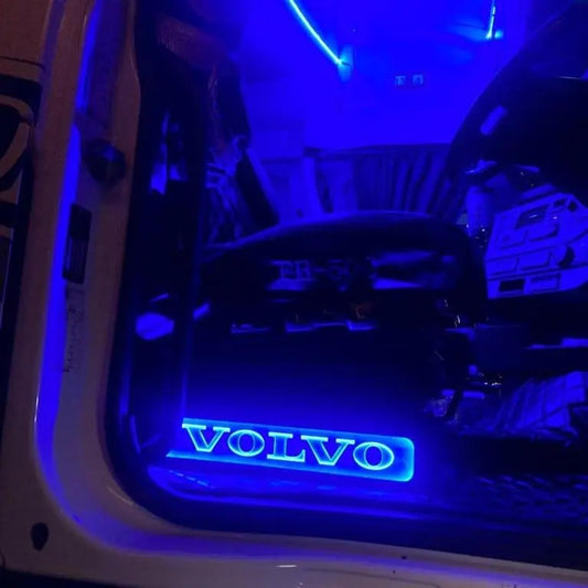 Volvo FH/FM Truck Black LED Seat Bases illuminate the cab interior, featuring blue-lit VOLVO door-sill and FH-500-marked seat, highlighting premium ECO Leather craftsmanship.