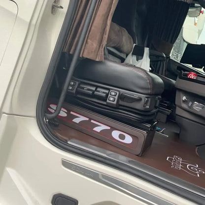 Interior view of a semi-truck cab featuring Scania Next Gen S650 LED Seat Bases Black With RED LED, adjustable driver's seat, and visible Mercedes-Benz badge.
