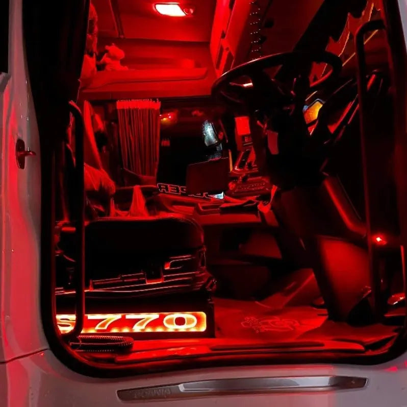 Scania Next Gen S650 LED Seat Bases in Black with RED LED, visible in a red-lit truck cabin, showcasing ECO Leather and wood craftsmanship.