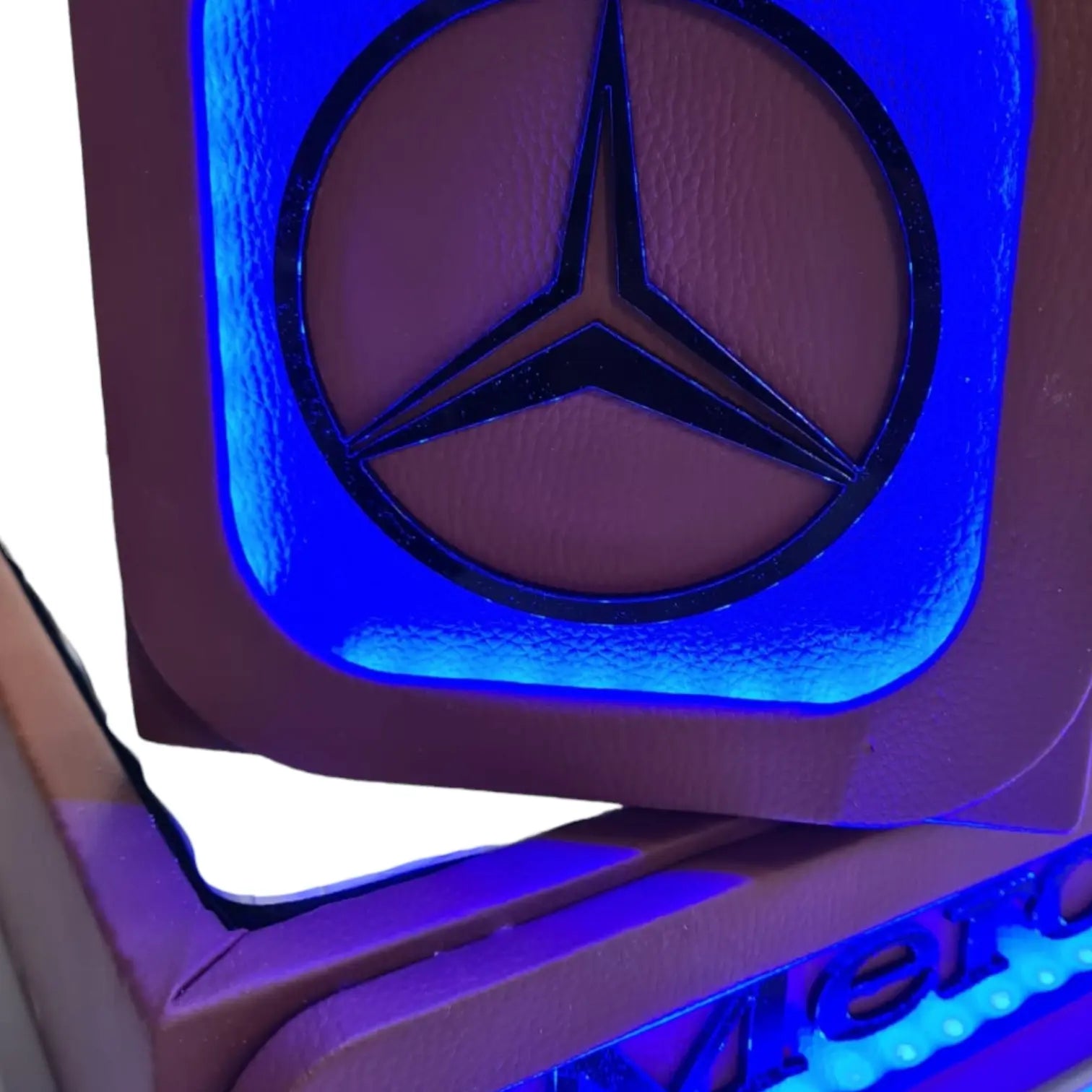 Mercedes MP4/5 Truck LED Seat Bases (Side Lit) featuring a backlit blue Mercedes emblem on a leather-wrapped panel, showcasing luxury and custom craftsmanship.