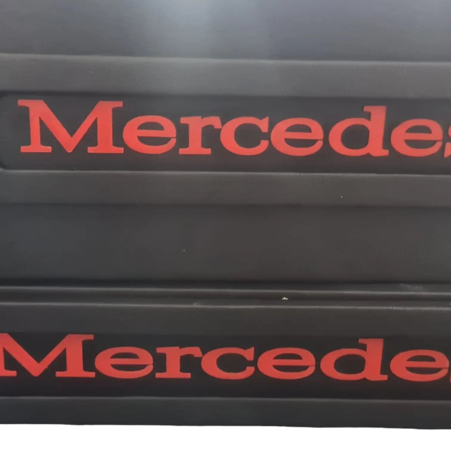 Mercedes MP4/5 Truck LED Seat Bases, featuring two black rectangular scuff-plates with red “Mercede” lettering, highlighting customizable, durable ECO Leather construction.