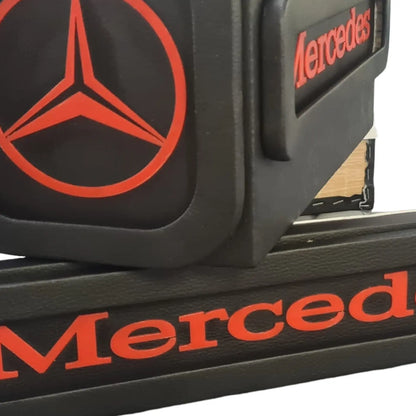 Close-up of a black Mercedes-branded armrest organizer with red logo, designed for Mercedes MP4/5 Truck LED Seat Bases, showcasing faux-leather finish.
