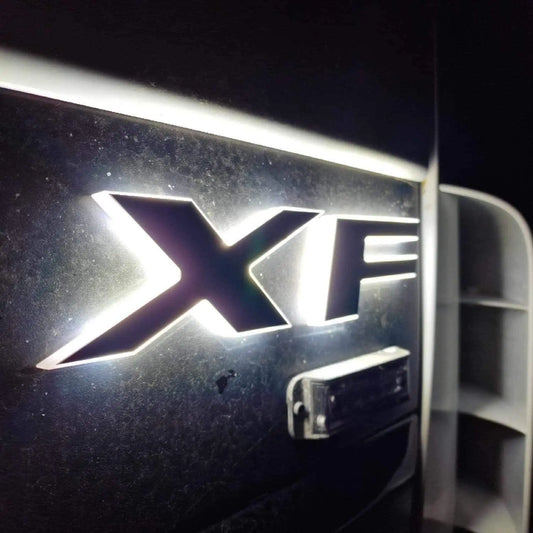 Close-up of the chrome XF model badge with back-lighting on a car, representing the DAF Euro 5 LED Name Badge for 24V vehicles.