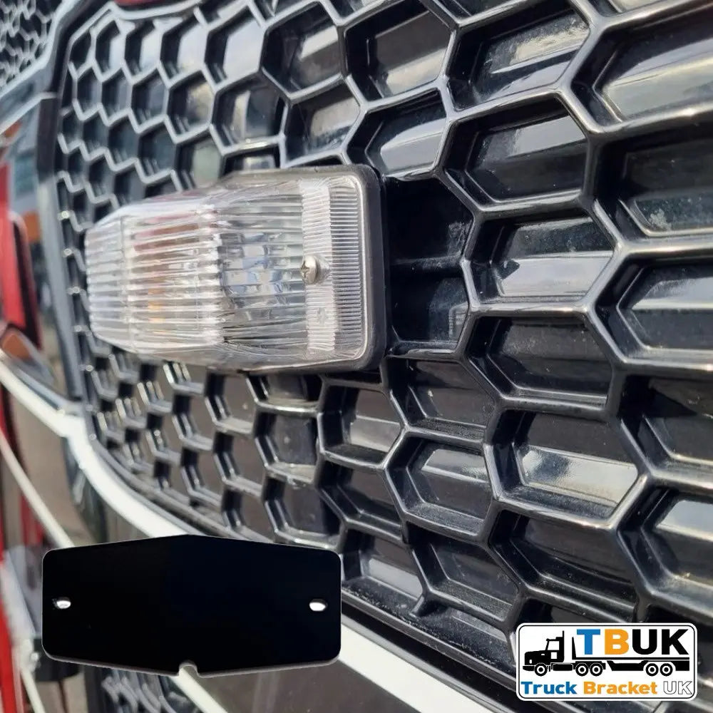 Close-up of Double Burner Light Backing Plate on truck grille, showing flat black metal bracket for mounting Halo Strobe lights with TBUK logo visible.