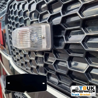Close-up of Double Burner Light Backing Plate on truck grille, showing flat black metal bracket for mounting Halo Strobe lights with TBUK logo visible.