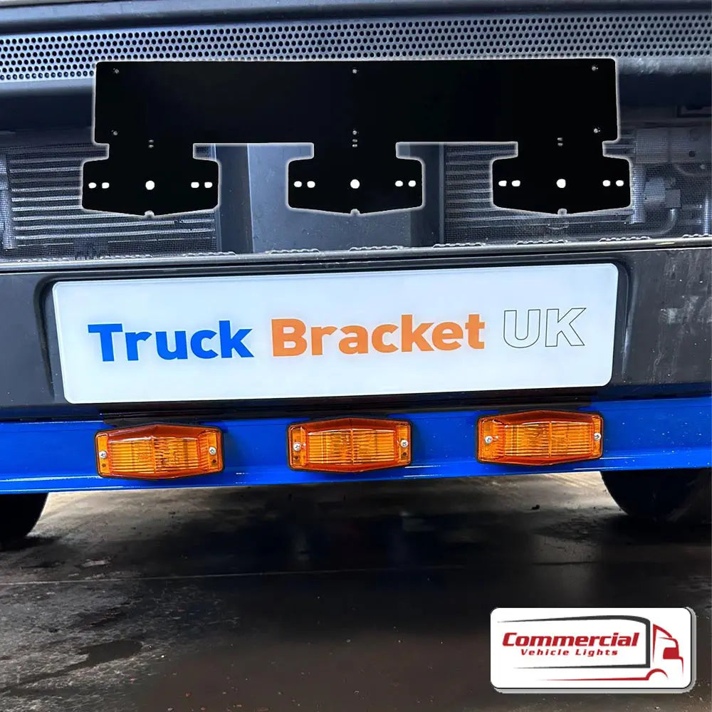 Double Burner Number Plate Mount on truck bumper, featuring blue cross-member with amber lights. Placard: Truck Bracket UK, logo: Commercial Vehicle Lights.