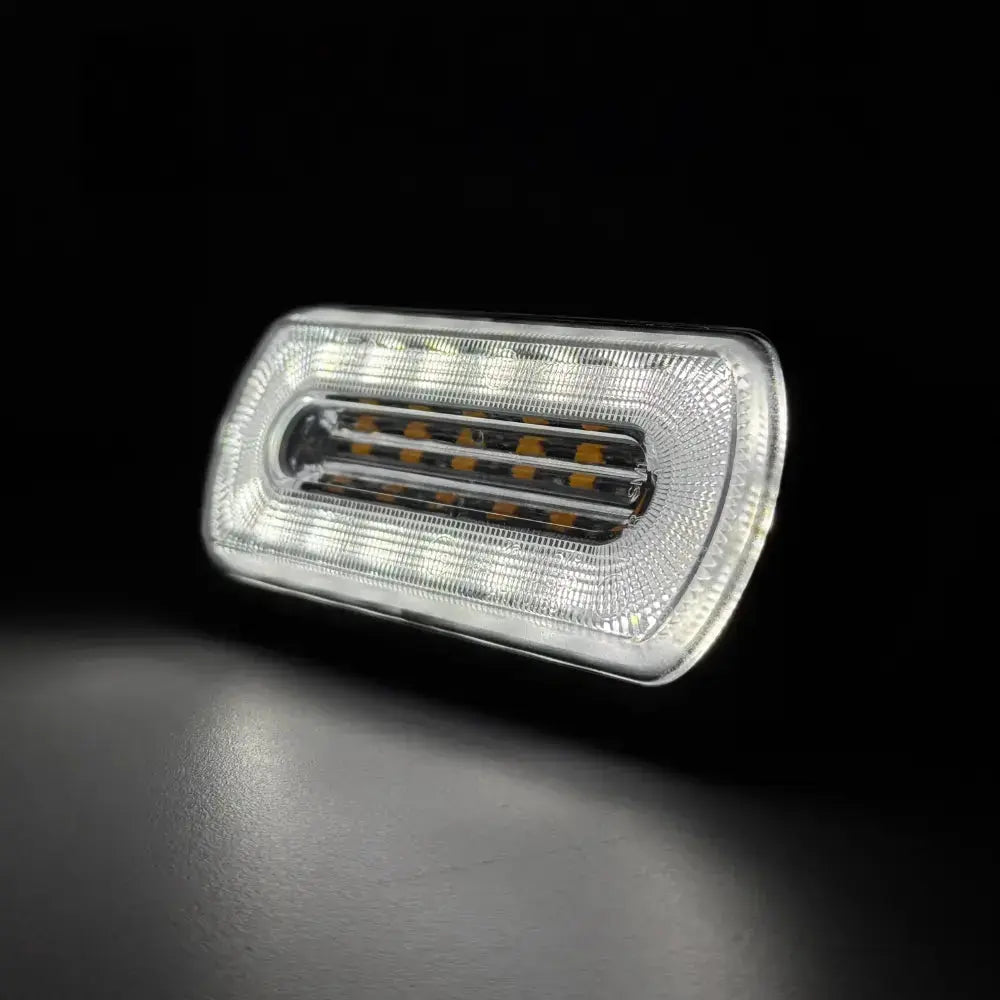 Amber HALO Strobe Warning Lamp R65 with a clear lens, featuring high-intensity white and amber LEDs for vehicle visibility and safety, suitable for 12/24v systems.