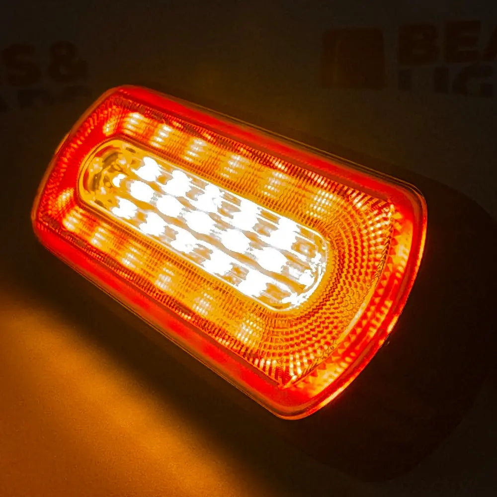Amber HALO Strobe Warning Lamp with translucent red lens, showcasing bright grid of LEDs, ideal for diverse vehicle lighting applications with compact design and dual voltage capability.