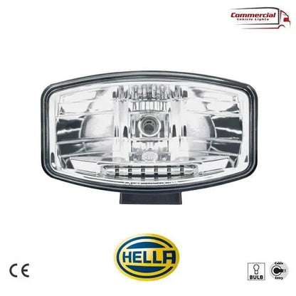 HELLA Jumbo 320 FF Spot Light with clear polycarbonate lens, reflector housing, and Hella logo. Replaceable bulb, cable-entry configuration, for 12/24V commercial vehicles.