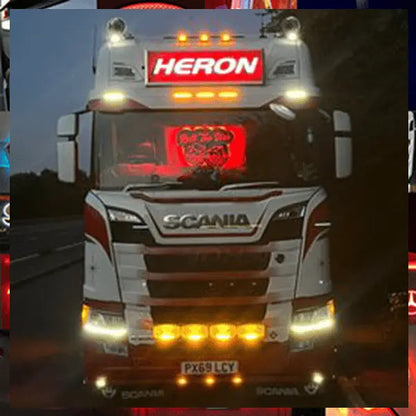 Scania truck with HERON LED headboard, part number DSH105x30STDW, featuring white LED illumination and multiple auxiliary lights, UK license PX69 LCY visible.