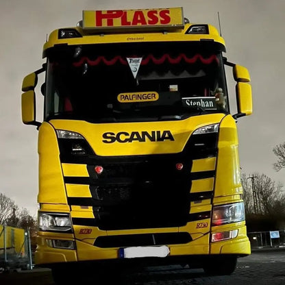 Front view of a Scania R-series semi-truck featuring a Dutch Style Illuminated LED Headboard with white LEDs, enhancing the cabin's visual appeal at night.