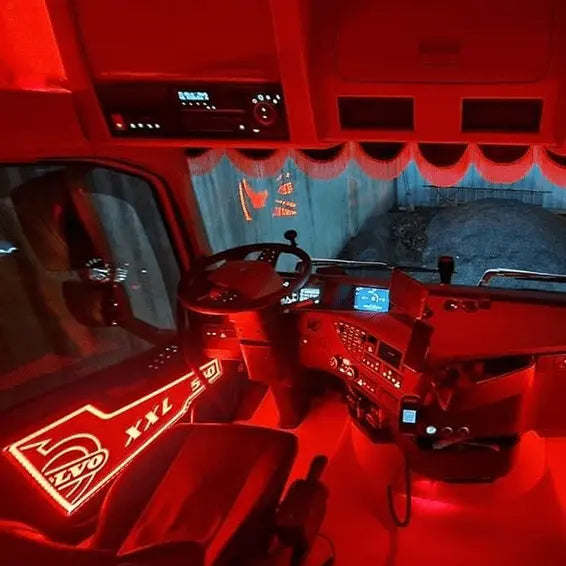 Volvo Fh/Fm LED Back-Lit Truck Interior Door Panels displayed in a semi-truck's red-lit cabin, highlighting the XXL logo and sleek digital interfaces.
