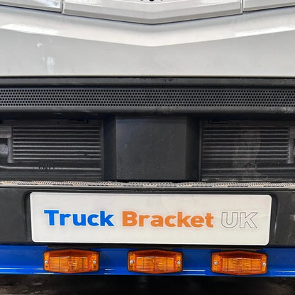 Close-up of the Mercedes Actros Double Burner Bumper Mount on a truck, featuring a promotional bracket and side-marker lights, designed for secure, stylish auxiliary lighting installation.