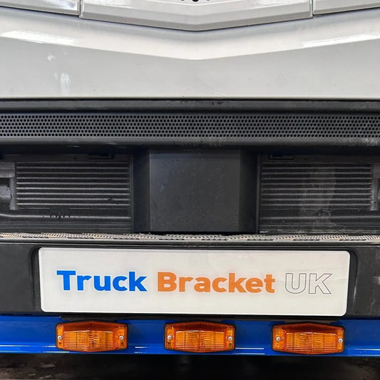 Close-up of the Mercedes Actros Double Burner Bumper Mount on a truck, featuring a promotional bracket and side-marker lights, designed for secure, stylish auxiliary lighting installation.