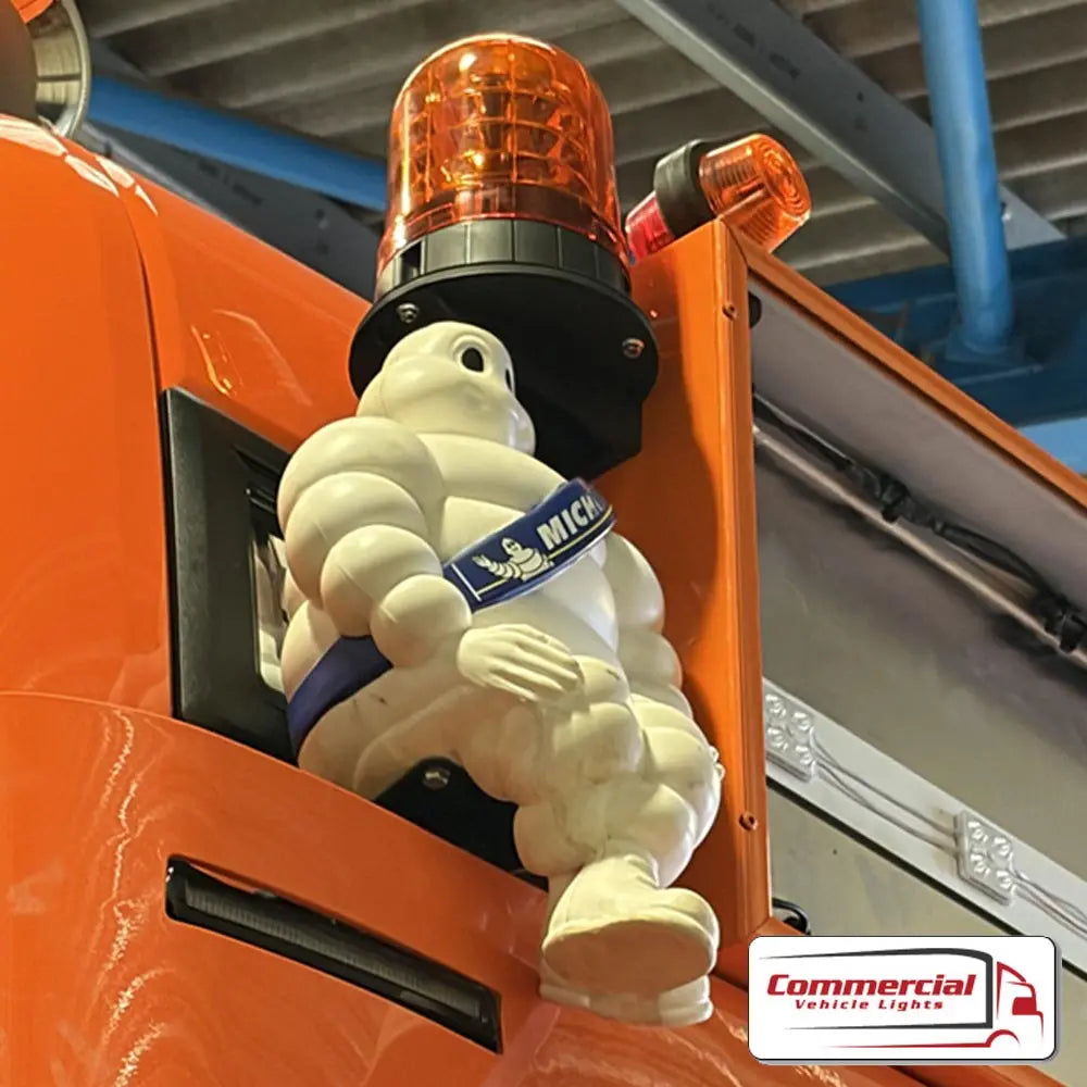 Michelin Man Mascot Headboard Mounts (Pair) displayed on an orange truck with an amber beacon, showcasing easy installation and durable, powder-coated stainless steel brackets.