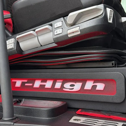 Renault T Range Truck LED Seat Bases (Side Lit) showing adjustment levers and illuminated “T-High” badge on driver’s seat side in heavy-truck cab interior.