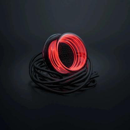 Strands FOR9T Geo Outline Marker Lights: A spool of glowing red LED rope lighting with translucent housing, coiled atop a dark surface, black power cable attached.