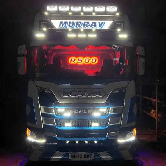 Scania R/S Series Truck Light Board on a cab-over semi-truck, featuring illuminated “R500” sign, “MURRAY” light bar, and decorative LED lights.