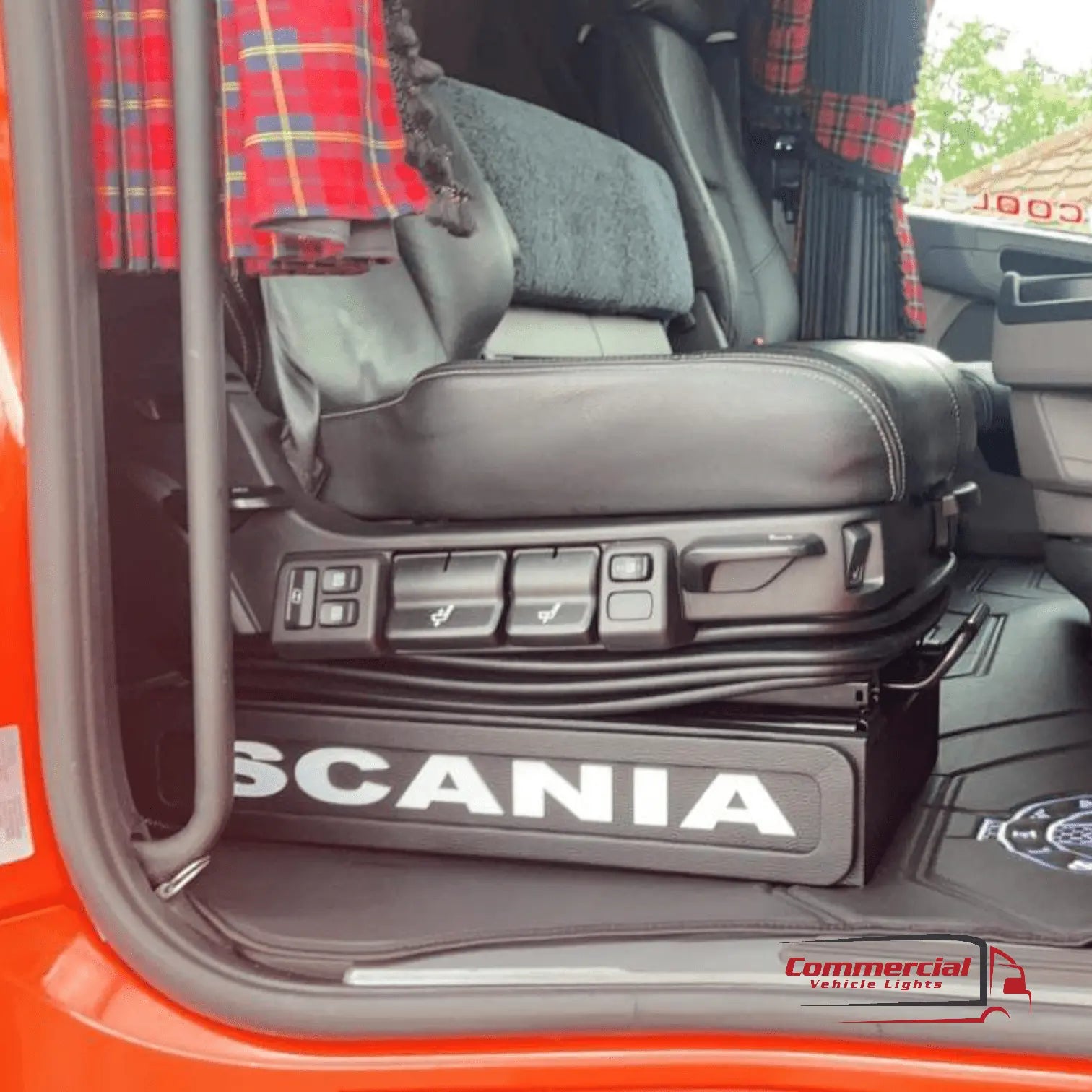 Interior of a Scania truck cab showcasing the Scania Next Gen S650 LED Seat Bases Black With RED LED, featuring electric adjustments and a Scania-branded seat base.