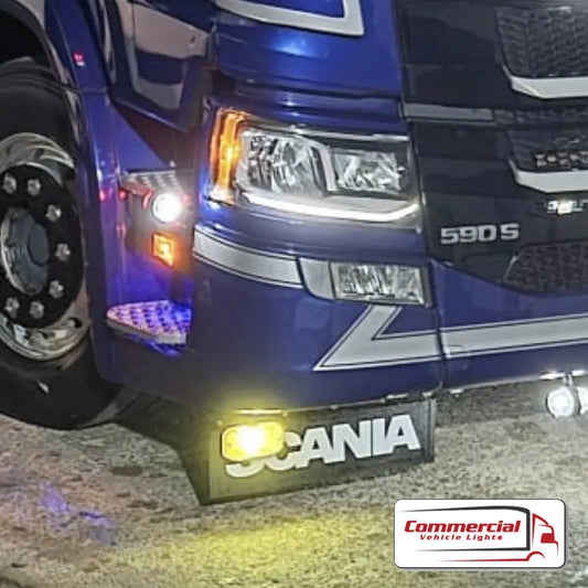 Blue Scania 590 S truck at night, showcasing illuminated bumper and side marker lights, highlighting the Next Gen Front Mudflap Mounting Bracket Kit (Scania Compatible).