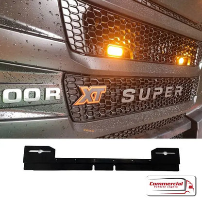 Next Gen R/S Series Grill Beacon/Strobe Light Mounting Bracket for Scania, featuring a black grille with amber lights and a durable, weather-resistant steel bracket for secure light attachment.