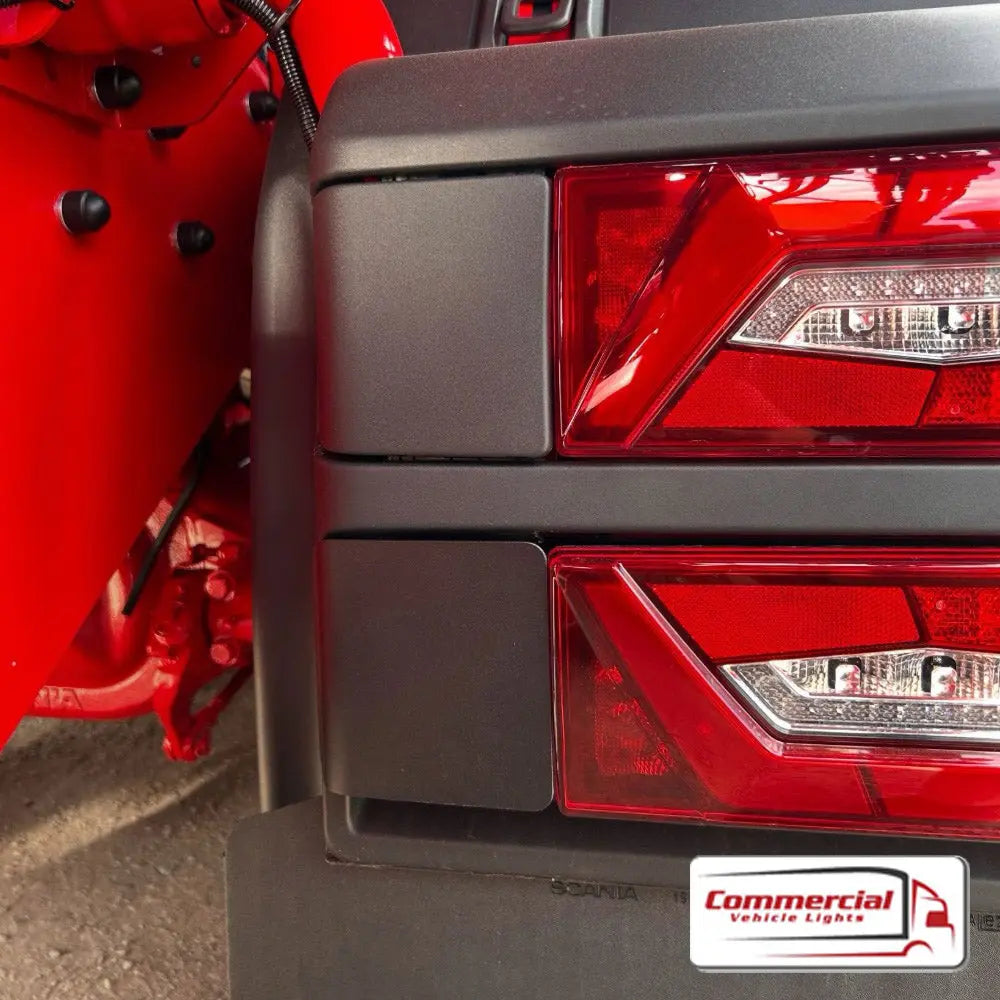 Rear Double Light Plug Cover (Stainless Steel) for Scania, shown in close-up, mounted over red LED tail-lights, enhancing truck aesthetics and protection.