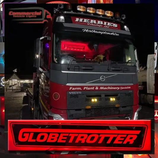 Volvo Globetrotter Mirror Fh Fm Fmx with RGB lights on a red-gray truck, night-lit, featuring HERBIE'S branding and amber roof lamps.