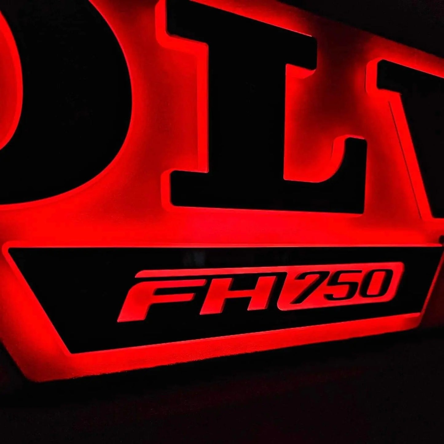 Volvo Badge LED Truck Light Board by TLD, featuring red backlit model “FH750,” on a silver pearl and black acrylic base, 100x30cm size.